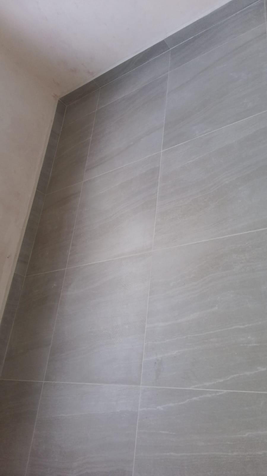 Finished grey wall tiling, corner detail